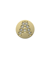 Gold charm with letter 'A' design on a white background